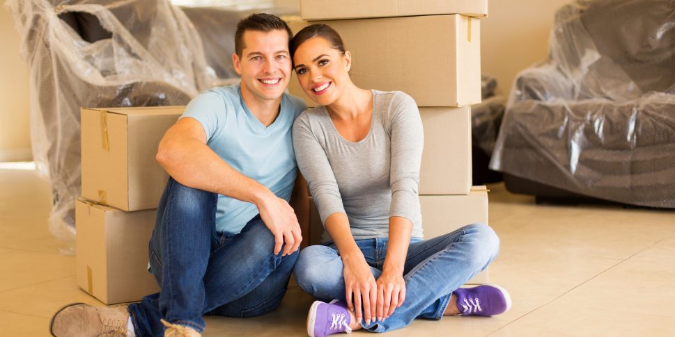Couple sitting in their home as they move house.